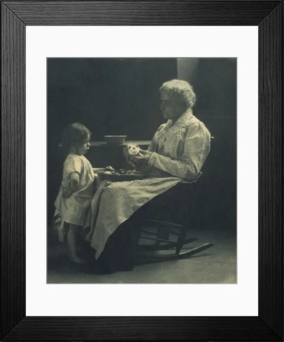 Framed Print : Elderly woman in a rocking chair peeling apple with young girl standing in front of her, c1900. Creator: Elizabeth B. Brownell Framed Print : Elderly woman in a rocking chair peeling apple with young girl standing in front of her, c1900. Creator: Elizabeth B. Brownell