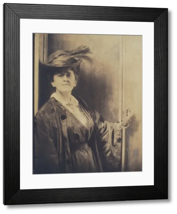 Framed Print : Gertrude Ka¨sebier, wearing feathered hat, standing, facing front, half-length portrait, c1900. Creator: Adolph de Meyer Framed Print : Gertrude Ka¨sebier, wearing feathered hat, standing, facing front, half-length portrait, c1900. Creator: Adolph de Meyer
