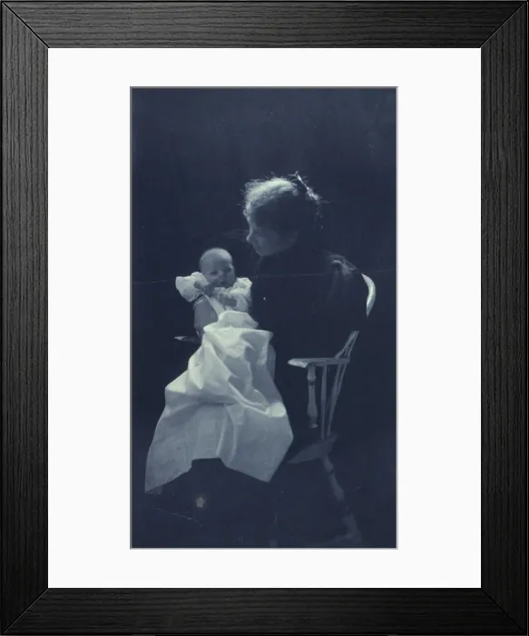 Framed Print : Woman, sitting in chair, holding an infant, full-length portrait, c1900. Creator: Sarah J. Eddy Framed Print : Woman, sitting in chair, holding an infant, full-length portrait, c1900. Creator: Sarah J. Eddy