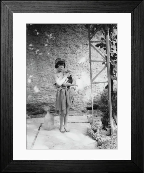 Framed Print : Kanellos child in dance costume holding a cat, 1929 Creator: Arnold Genthe Framed Print : Kanellos child in dance costume holding a cat, 1929 Creator: Arnold Genthe