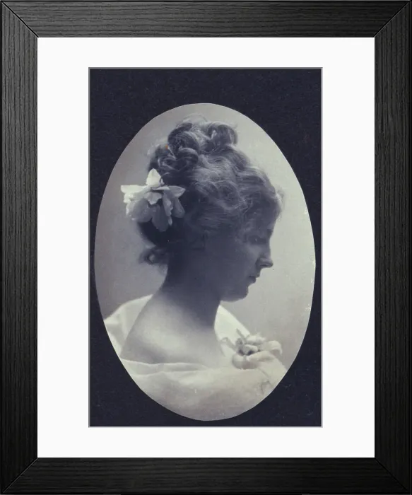 Framed Print : Oval portrait of woman with a flower in her hair and a corsage on her dress, c1900. Creator: Fannie L. Elton Framed Print : Oval portrait of woman with a flower in her hair and a corsage on her dress, c1900. Creator: Fannie L. Elton