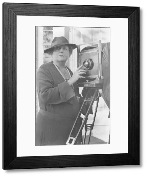 Framed Print : Frances Benjamin Johnston, 1864-1952, half length, facing front, adjusting lens... c1936. Creator: Frances Benjamin Johnston Framed Print : Frances Benjamin Johnston, 1864-1952, half length, facing front, adjusting lens... c1936. Creator: Frances Benjamin Johnston