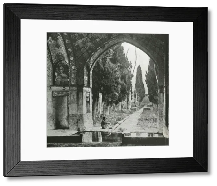 Framed Print : Reproduction of print showing Garden at Fin-Nahe¯, Kashan, Iran. Man seated under arch, c1920. Creator: Frances Benjamin Johnston Framed Print : Reproduction of print showing Garden at Fin-Nahe¯, Kashan, Iran. Man seated under arch, c1920. Creator: Frances Benjamin Johnston