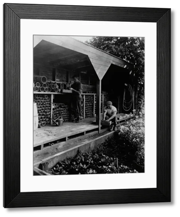 Framed Print : Gardeners potting plants in a shed, posed to...Rudyard Kipling's poem The Glory of the Garden, 1917. Creator: Frances Benjamin Johnston Framed Print : Gardeners potting plants in a shed, posed to...Rudyard Kipling's poem The Glory of the Garden, 1917. Creator: Frances Benjamin Johnston