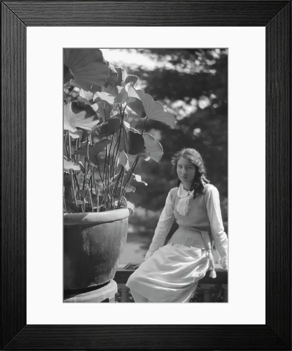 Framed Print : Unidentified woman seated in a garden next to a large potted plant, between 1917 and 1934. Creator: Arnold Genthe Framed Print : Unidentified woman seated in a garden next to a large potted plant, between 1917 and 1934. Creator: Arnold Genthe