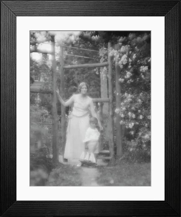 Framed Print : Conroy, Frank, Mrs. and child, standing by a garden gate, 1923 Creator: Arnold Genthe Framed Print : Conroy, Frank, Mrs. and child, standing by a garden gate, 1923 Creator: Arnold Genthe