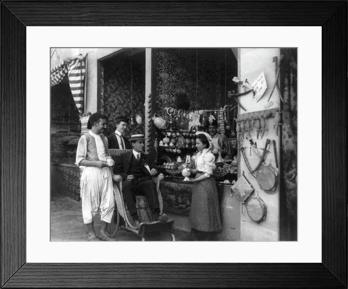 Framed Print : Pan-American Exposition, Buffalo, N.Y. 1901: Man in wheeled chair at souvenir shop with 4... 1901. Creator: Frances Benjamin Johnston Framed Print : Pan-American Exposition, Buffalo, N.Y. 1901: Man in wheeled chair at souvenir shop with 4... 1901. Creator: Frances Benjamin Johnston