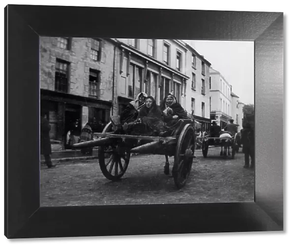 Killarney - 3 Irish women going to a funeral in a horse-drawn cart, (1899?). Creator: Frances Benjamin Johnston