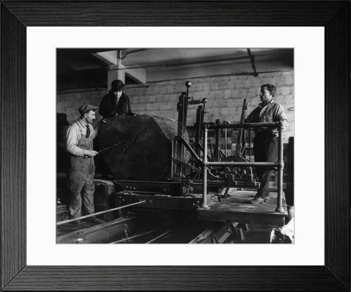 Framed Print : Wooden box industry - Mrs. Graham inspecting log on machinery with two workmen standing by, c1910. Creator: Frances Benjamin Johnston Framed Print : Wooden box industry - Mrs. Graham inspecting log on machinery with two workmen standing by, c1910. Creator: Frances Benjamin Johnston