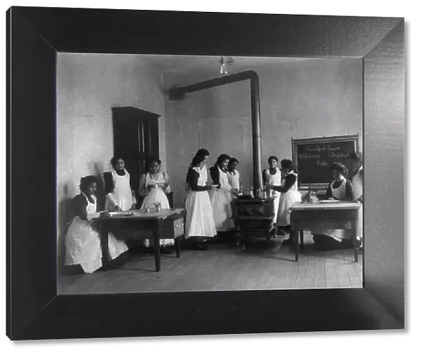 Breakfast lesson in home economics class for women. Carlisle Indian School, Pa. 1901. Creator: Frances Benjamin Johnston