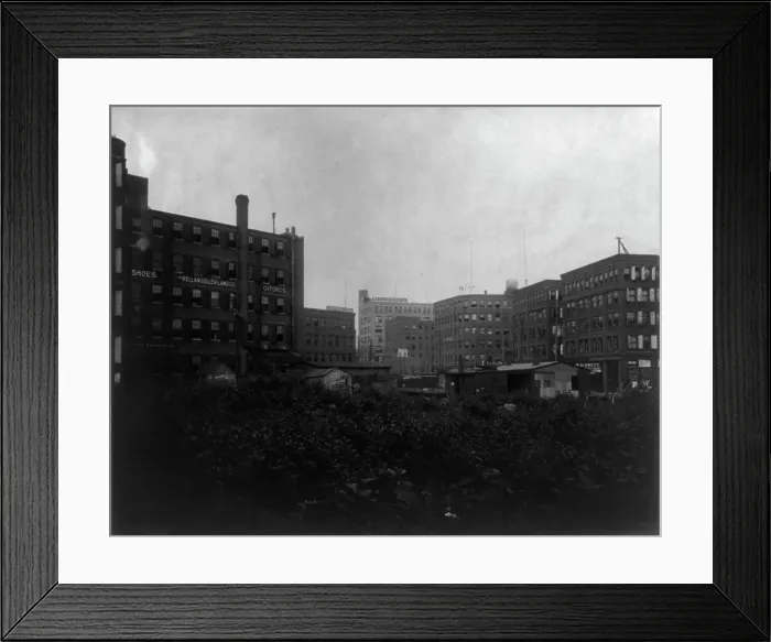 Framed Print : Shoe factories, Lynn, Mass.: exterior view of shoe factories and other buildings, (1895?). Creator: Frances Benjamin Johnston Framed Print : Shoe factories, Lynn, Mass.: exterior view of shoe factories and other buildings, (1895?). Creator: Frances Benjamin Johnston