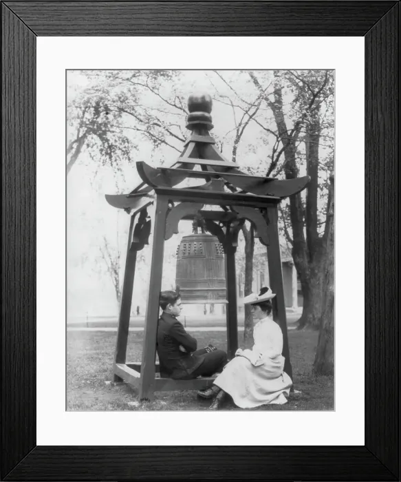 Framed Print : U.S. Naval Academy, Annapolis, Md. 1902?: midshipman and girl sitting beneath bell, (1902?). Creator: Frances Benjamin Johnston Framed Print : U.S. Naval Academy, Annapolis, Md. 1902?: midshipman and girl sitting beneath bell, (1902?). Creator: Frances Benjamin Johnston
