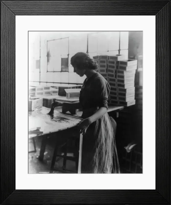Framed Print : Girl painting strips with glue to assemble cigar boxes, c1910. Creator: Frances Benjamin Johnston Framed Print : Girl painting strips with glue to assemble cigar boxes, c1910. Creator: Frances Benjamin Johnston