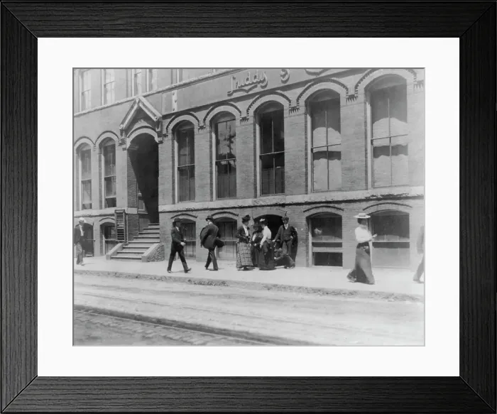Framed Print : Massachusetts. Lynn. shoe factories, 1895?: sidewalk scene outside Luddy Co. (1895?). Creator: Frances Benjamin Johnston Framed Print : Massachusetts. Lynn. shoe factories, 1895?: sidewalk scene outside Luddy Co. (1895?). Creator: Frances Benjamin Johnston