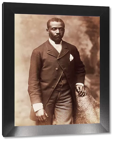 Studio portrait of a man dressed in jacket, vest, tie and striped pants, c1880-c1889. Creator: Alexander Hesler