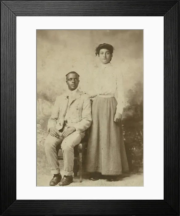 Framed Print : Studio portrait of a young couple, he seated, she with hand on his shoulder, c1900. Creator: Carbon Studio Framed Print : Studio portrait of a young couple, he seated, she with hand on his shoulder, c1900. Creator: Carbon Studio