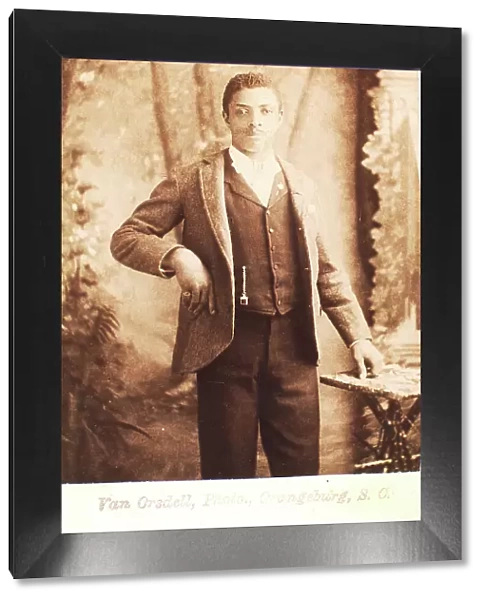 Studio portrait of man, hand on waist, (1880-1940?). Creator: Van Orsdell