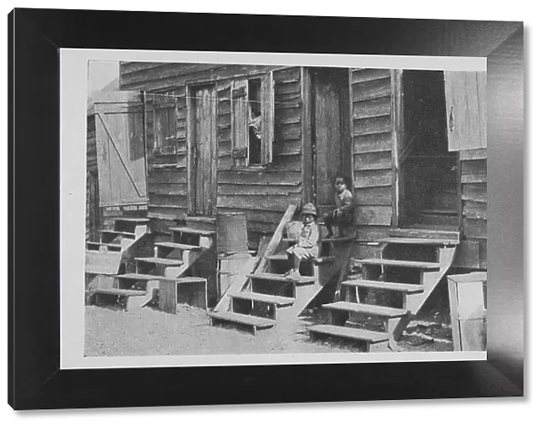 African American children sitting on the stairs in front of their house, 1922. Creator: Unknown
