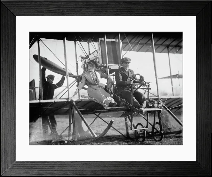 Framed Print : Senorita Lenore Riviero [sic] with Anthony Jannus; In Rex Smith Aeroplane, 1912. Creator: Harris & Ewing. Senorita Lenore Riviero [sic] with Anthony Jannus; In Rex Smith Aeroplane, 1912. Creator: Harris & Ewing
