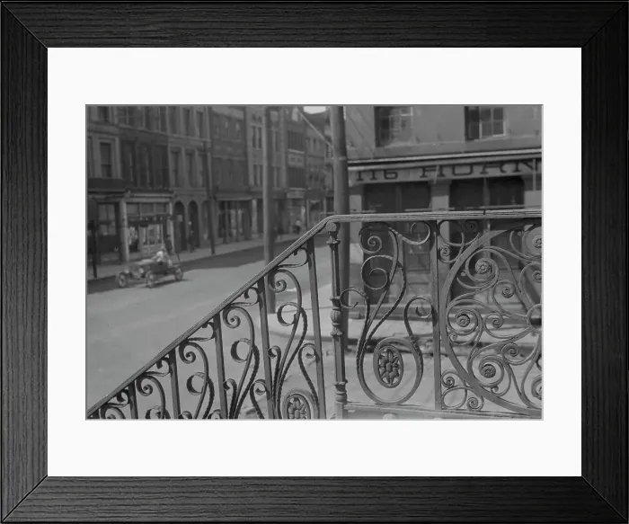 Framed Print : Street seen from behind the wrought iron railing of the Market Hall, Charleston... c1920-c1926. Creator: Arnold Genthe Framed Print : Street seen from behind the wrought iron railing of the Market Hall, Charleston... c1920-c1926. Creator: Arnold Genthe