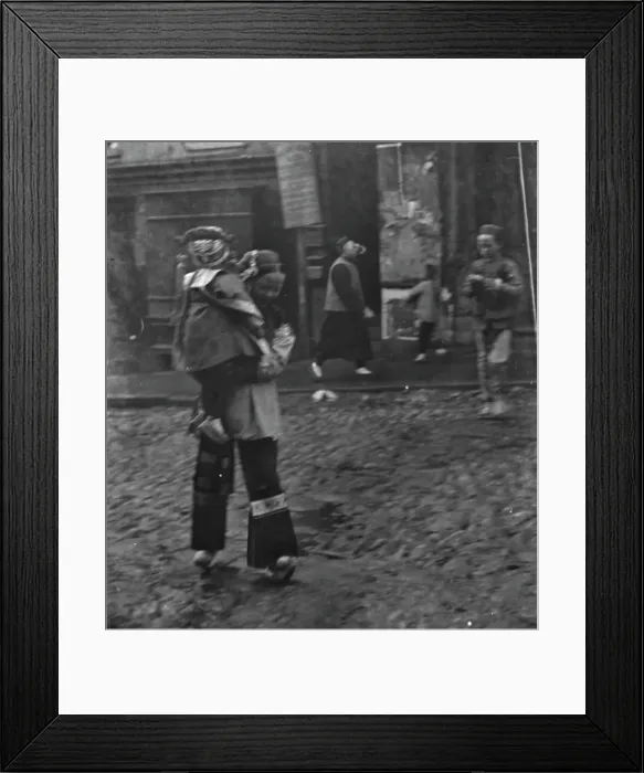 Framed Print : Woman carrying a child crossing a street, Chinatown, San Francisco, between 1896 and 1906. Creator: Arnold Genthe Framed Print : Woman carrying a child crossing a street, Chinatown, San Francisco, between 1896 and 1906. Creator: Arnold Genthe