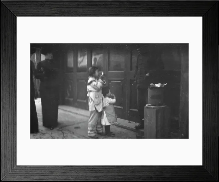 Framed Print : Two children standing on a sidewalk eating, Chinatown, San Francisco, between 1896 and 1906. Creator: Arnold Genthe