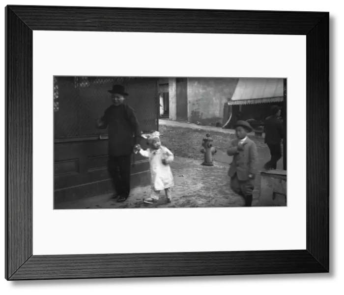 Framed Print : Man and a young child walking down a street, Chinatown, San Francisco, between 1896 and 1906. Creator: Arnold Genthe Framed Print : Man and a young child walking down a street, Chinatown, San Francisco, between 1896 and 1906. Creator: Arnold Genthe