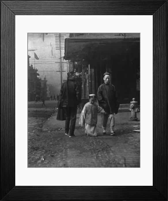 Framed Print : Boy and a man smoking a cigar crossing the street, San Francisco, between 1896 and 1906. Creator: Arnold Genthe Framed Print : Boy and a man smoking a cigar crossing the street, San Francisco, between 1896 and 1906. Creator: Arnold Genthe