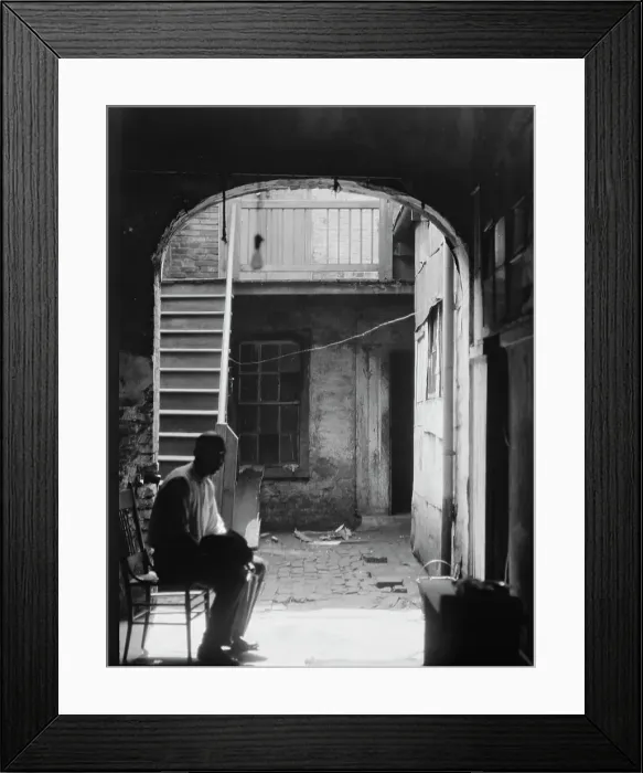 Framed Print : Man seated in archway leading to a courtyard, New Orleans, between 1920 and 1926. Creator: Arnold Genthe Framed Print : Man seated in archway leading to a courtyard, New Orleans, between 1920 and 1926. Creator: Arnold Genthe