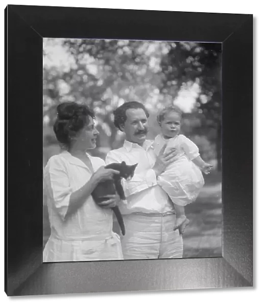 Nadelman, Mr. and Mrs. with baby and cat, standing outdoors, 1923 July 12. Creator: Arnold Genthe