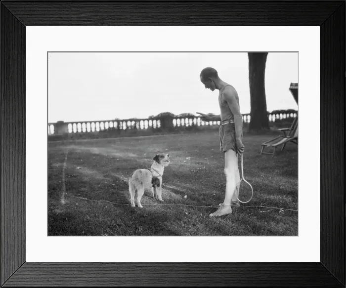 Framed Print : Cosgrave, Mr. with dog, outdoors, not before 1917. Creator: Arnold Genthe Framed Print : Cosgrave, Mr. with dog, outdoors, not before 1917. Creator: Arnold Genthe