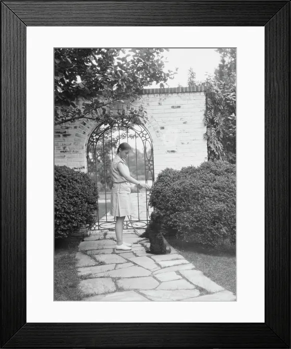 Framed Print : Brady, Genevieve, Miss, with dog, standing outdoors, between 1928 and 1931. Creator: Arnold Genthe Framed Print : Brady, Genevieve, Miss, with dog, standing outdoors, between 1928 and 1931. Creator: Arnold Genthe