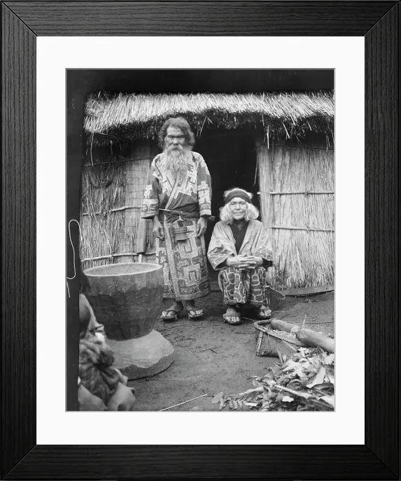 Framed Print : Ainu man and seated woman at the entrance of a hut, 1908. Creator: Arnold Genthe Framed Print : Ainu man and seated woman at the entrance of a hut, 1908. Creator: Arnold Genthe