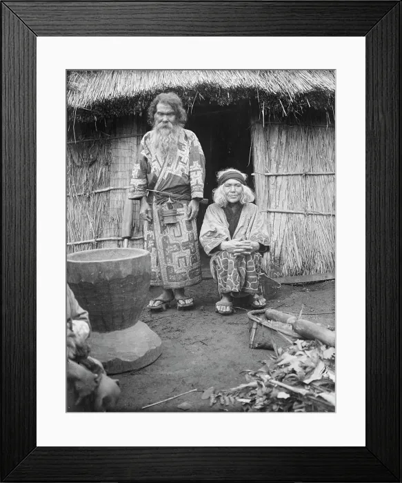 Framed Print : Ainu man and seated woman at the entrance of a hut, 1908. Creator: Arnold Genthe Framed Print : Ainu man and seated woman at the entrance of a hut, 1908. Creator: Arnold Genthe