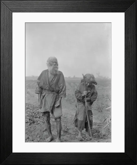 Framed Print : Ainu man and woman standing outside, 1908. Creator: Arnold Genthe Framed Print : Ainu man and woman standing outside, 1908. Creator: Arnold Genthe