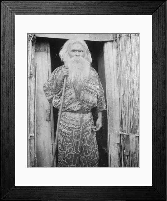 Framed Print : Ainu man holding a staff standing at the doorway of a hut, 1908. Creator: Arnold Genthe Framed Print : Ainu man holding a staff standing at the doorway of a hut, 1908. Creator: Arnold Genthe