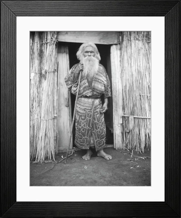 Framed Print : Ainu man holding a staff standing at the doorway of a hut, 1908. Creator: Arnold Genthe Framed Print : Ainu man holding a staff standing at the doorway of a hut, 1908. Creator: Arnold Genthe
