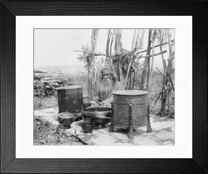 Framed Print : Ainu man seated outdoors on a mat covered with clay containers, 1908. Creator: Arnold Genthe Framed Print : Ainu man seated outdoors on a mat covered with clay containers, 1908. Creator: Arnold Genthe