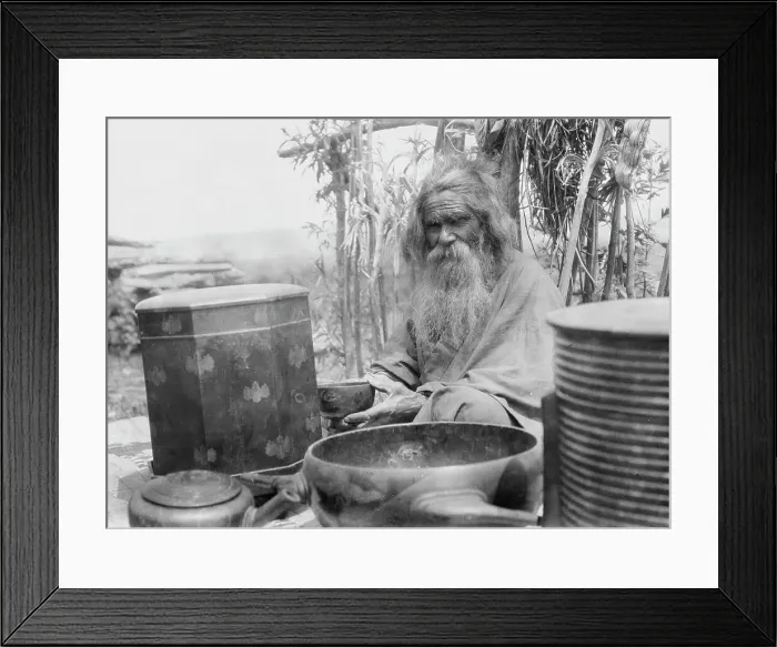 Framed Print : Ainu man seated outdoors on a mat covered with clay containers, 1908. Creator: Arnold Genthe Framed Print : Ainu man seated outdoors on a mat covered with clay containers, 1908. Creator: Arnold Genthe