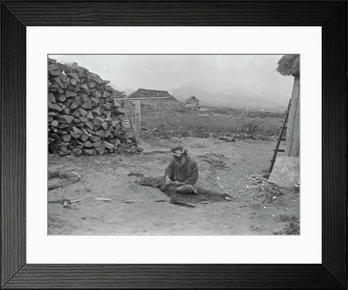 Framed Print : Ainu man seated outside working on nets, 1908. Creator: Arnold Genthe Framed Print : Ainu man seated outside working on nets, 1908. Creator: Arnold Genthe