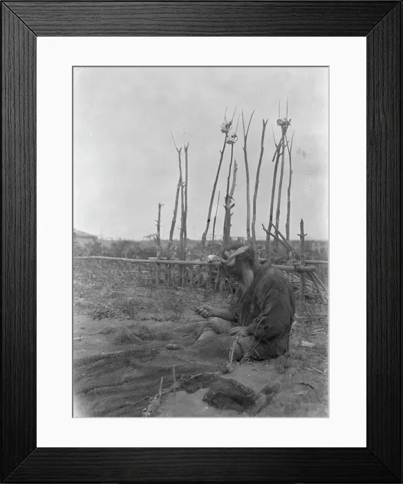 Framed Print : Ainu seated outside working on nets, 1908. Creator: Arnold Genthe Framed Print : Ainu seated outside working on nets, 1908. Creator: Arnold Genthe