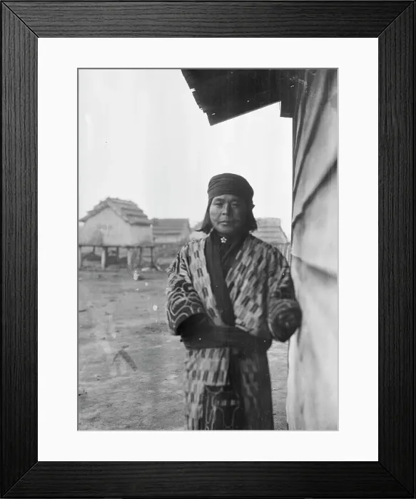 Framed Print : Ainu standing outside by the wall of a wooden hut, 1908. Creator: Arnold Genthe Framed Print : Ainu standing outside by the wall of a wooden hut, 1908. Creator: Arnold Genthe