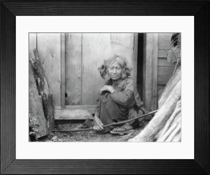 Framed Print : Ainu woman seated by the door of a wooden hut, 1908. Creator: Arnold Genthe Framed Print : Ainu woman seated by the door of a wooden hut, 1908. Creator: Arnold Genthe