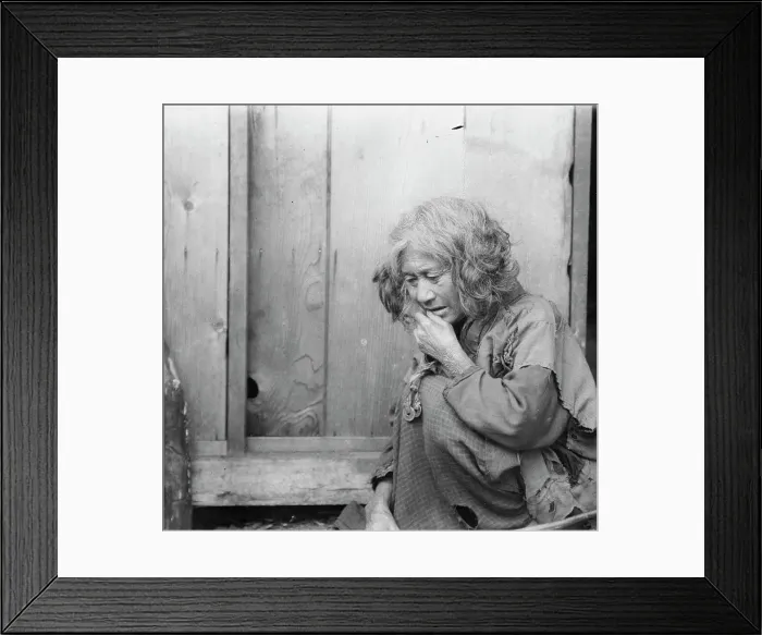 Framed Print : Ainu woman seated by the door of a wooden hut, 1908. Creator: Arnold Genthe Framed Print : Ainu woman seated by the door of a wooden hut, 1908. Creator: Arnold Genthe