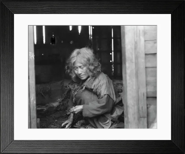 Framed Print : Ainu woman seated in the doorway of a wooden hut, 1908. Creator: Arnold Genthe Framed Print : Ainu woman seated in the doorway of a wooden hut, 1908. Creator: Arnold Genthe