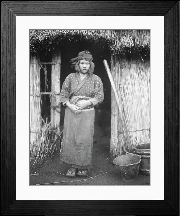 Framed Print : Ainu woman standing by the doorway of a hut, 1908. Creator: Arnold Genthe Framed Print : Ainu woman standing by the doorway of a hut, 1908. Creator: Arnold Genthe