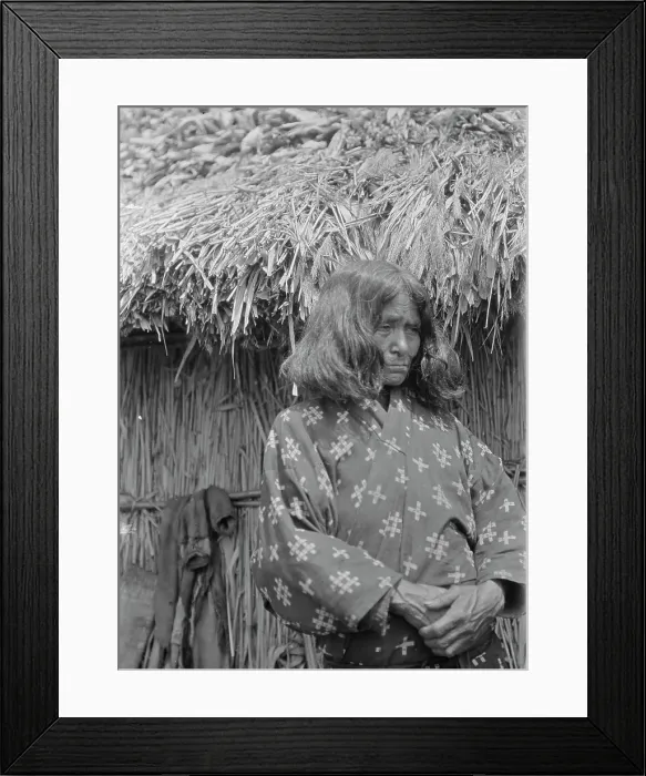 Framed Print : Ainu woman standing outside a hut, 1908. Creator: Arnold Genthe Framed Print : Ainu woman standing outside a hut, 1908. Creator: Arnold Genthe