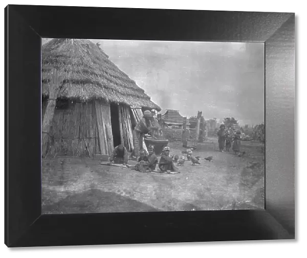 Ainu women and children outside a hut, 1908. Creator: Arnold Genthe