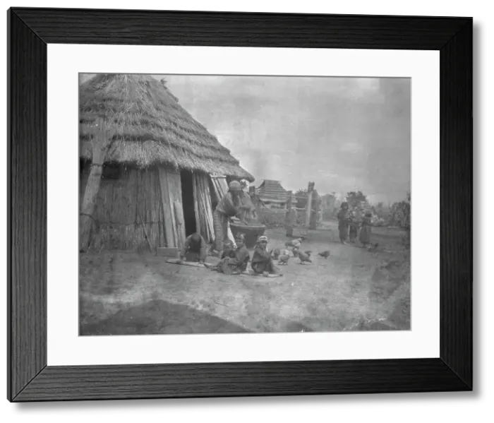 Framed Print : Ainu women and children outside a hut, 1908. Creator: Arnold Genthe Framed Print : Ainu women and children outside a hut, 1908. Creator: Arnold Genthe