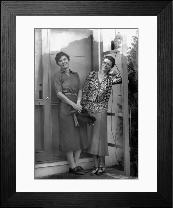 Framed Print : Mrs. Mary Benson and Alice DeLamar, standing by the door of a house, 1933. Creator: Arnold Genthe Framed Print : Mrs. Mary Benson and Alice DeLamar, standing by the door of a house, 1933. Creator: Arnold Genthe